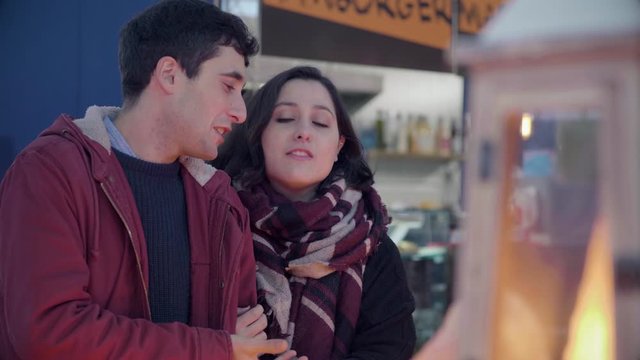 portrait of romatic couple in the store buying christmas gifts kissing