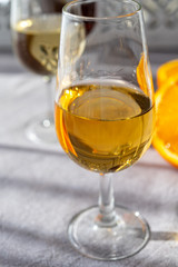 Glass with cold fino sherry fortified wine in sunlights, andalusian style interior on background