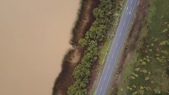 Aerial drone flying top-down over the Wairoa River and State Highway Twelve near Dargaville in Northland, New Zealand