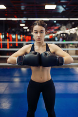 Woman in black boxing gloves, front view