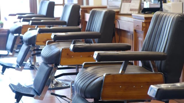 Horizontal shot of empty chairs in retro styled barbershop. Hair salon interior.