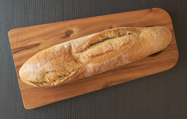 rye flour baguette on an acacia cutting board
