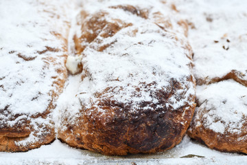 Traditional homemade apple pie roll or strudel for sale during food market or festival