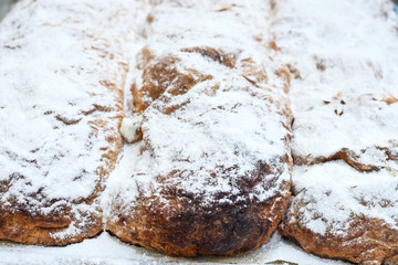 Traditional homemade apple pie roll or strudel for sale during food market or festival