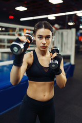 Woman doing exercise with dumbbells, box training
