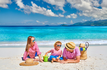 Family with three year old boy on beach. Seychelles, Mahe.