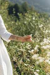 a happy girl in a hat walks through a field of daisiesa happy girl in a hat walks through a field of daisies