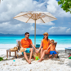 Family with three year old boy on beach. Seychelles, Mahe.