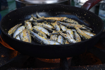 Freshly grilled fish on counter top stall, during seafood festival, street food market.