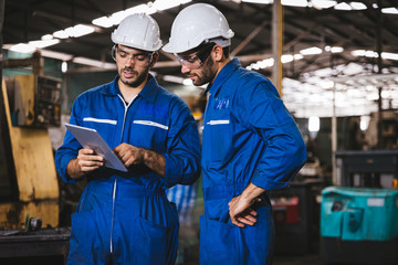 Industry maintenance engineer wearing uniform and safety helmet under inspection and checking...