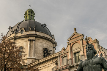 Monument of Ivan Fyodorov and dominican holy eucharist church in Lviv Ukraine. Neo-baroque temple with beautiful cupola.