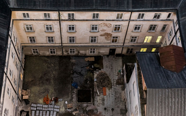 Fototapeta premium Top view from city hall tower in Lviv, Ukraine. View of courtyard and devastated facade of town hall. 