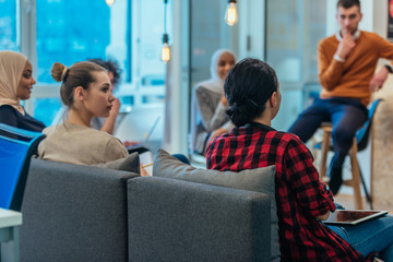 Business meeting between multi ethnic colleagues in a modern startup company.