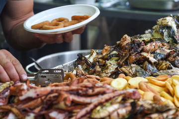 Freshly grilled fish on counter top stall, during seafood festival, street food market.