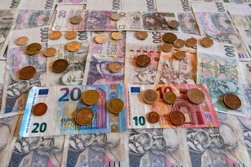 Fototapeta na wymiar coins and banknote, euro and crown side by side, CZK EURO EUR