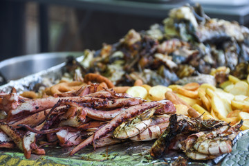 Freshly grilled fish on counter top stall, during seafood festival, street food market.