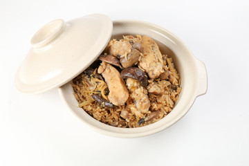 Clay pot chicken rice with mushroom in clay ceramic bowl on white background