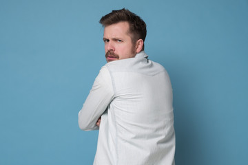 Caucasian man turning back looking at camera.