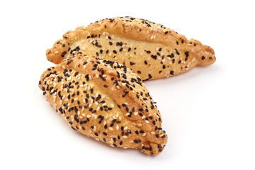 Freshly baked patties with sesame seeds, isolated on white background
