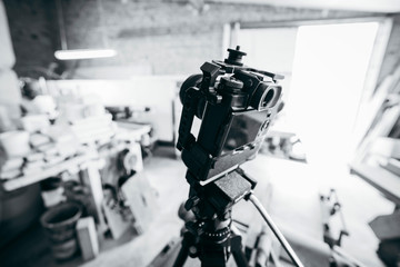 Camera set up on tripod recording production in carpentry