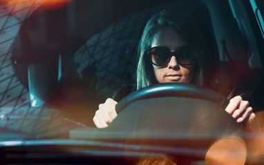 Young woman with sunglasses driving