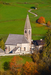 Autumn morning Santa Magdalena famous Italy Dolomites mountain village church