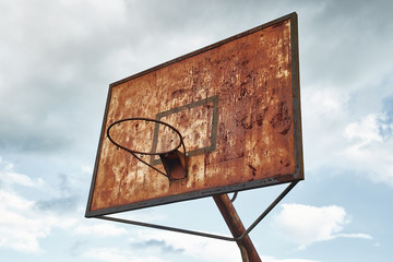 Decaying rusty basketball dunk on an abandoned playground