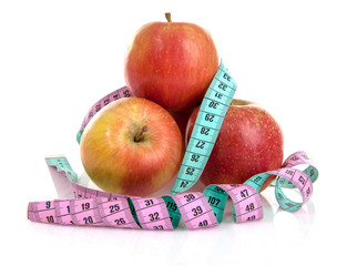 Diet scenery with measuring tape and fresh strawberries over white background