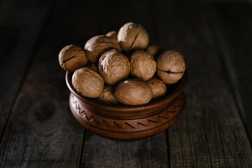 walnuts in earthenware on a wooden table