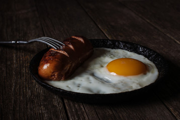 fried egg and sausage in a pan