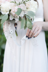 Wedding morning bride with peonies. wedding bouquet in the hands of the bride. lovely woman in a wedding dress