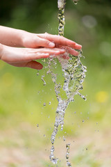公園で水道水を使って手を洗う子供