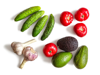 Avocado, cucumbers, tomatoes and garlic on a white background