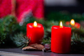 Night image of coffee table with authentic Chrismas decoration and lit candles.