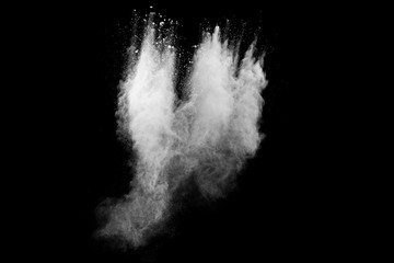 Freeze motion of white dust particles splash on black background.White powder explosion clouds.