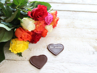 Fototapeta na wymiar Muttertagsgrüße mit Rosen und Schokoladenherzen