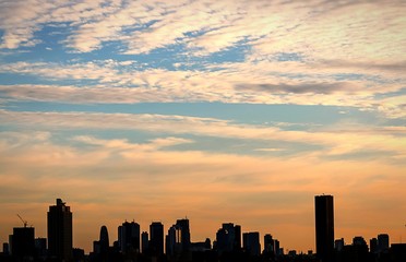 Fototapeta na wymiar Cityscape Against Cloudy Sky During Sunset