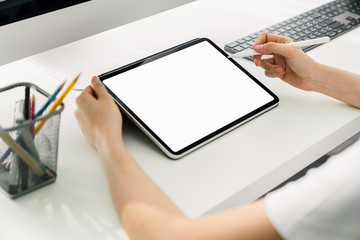 Woman holding digital tablet mockup of blank screen and computer on the table office. Take your screen to put on advertising.