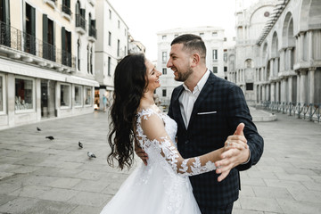 bride and groom on the background of a historic building,bride and groom walk the streets of the...