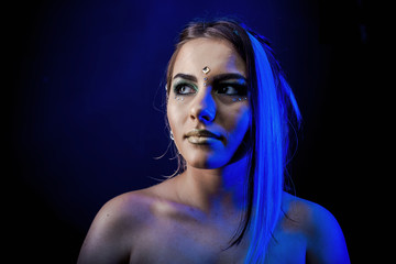 ethnic girl on a black background in blue light