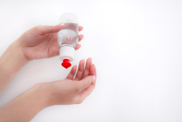 female hands apply a clear liquid from a bottle on a white background