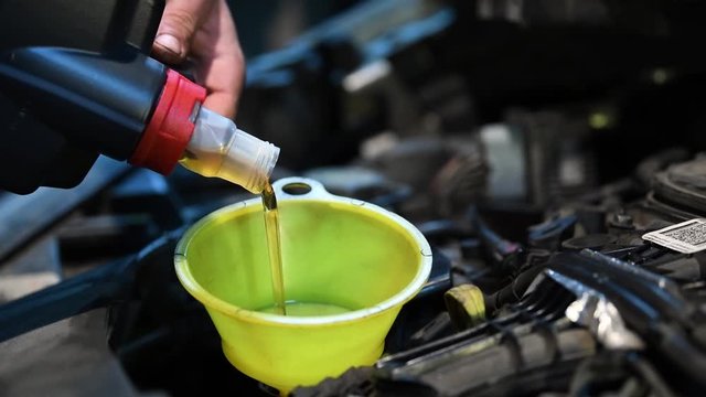 Oil replacement at sheduled service interval. Automobile maintenance. Lubricating and oiling