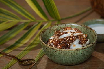 Tapioca pearls form sago tree. Still life photography of Thai dessert Sago palms with coconuts or sago pearls in coconut milk on the table. Popular dessert in Thailand served with fresh coconut milk.
