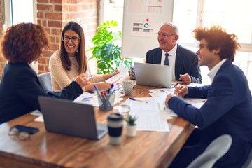 Group of business workers smiling happy and confident. Speaking with smile on face working together at the office.