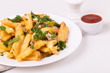 Canadian poutine french fries with brown gravy sauce, chicken and cheese curds.