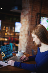 Modern student with laptop in cafe
