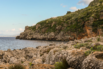 Fototapeta na wymiar Mediterranean landscape of Sicily, Italy. View shot in Zingaro Nature Reserve. Mix of azur water, rock, coast, mountain, plants, sea, flora and hill. 