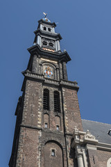 Fototapeta na wymiar View of Western Church (Westerkerk, 1620 - 1631) - a Dutch Protestant church in Amsterdam. It lies in the most western part of the Grachtengordel neighborhood. Amsterdam, Netherlands.