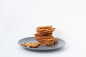 Waffle cookies in a blue plate isolated on a white background.