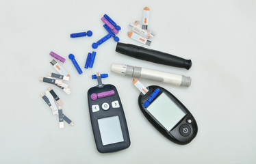 2 Diabetes set with glucometer, lancet, spare needles on white  background 